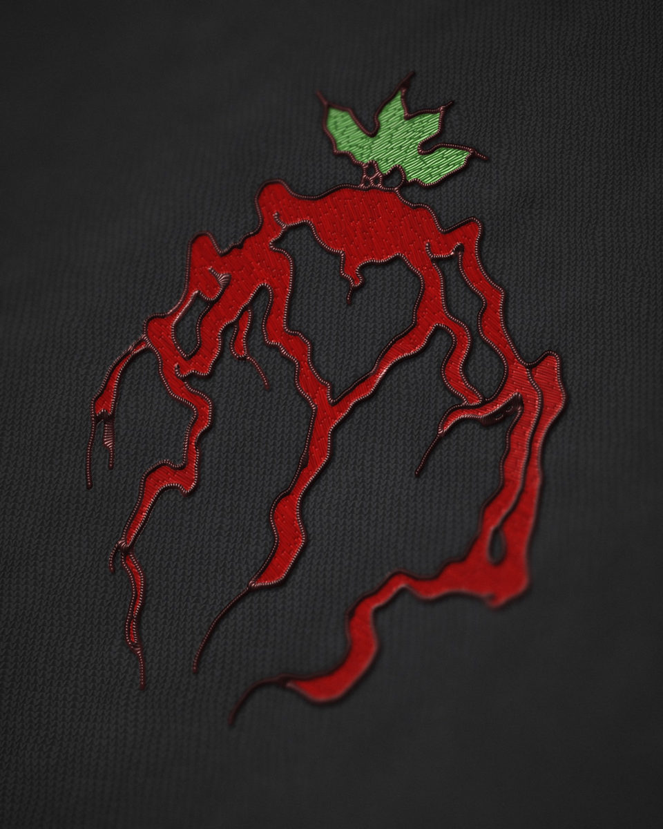 Embroidered patch of a heart whose roots run like veins, in red stitching with a single green leaf, on black knit